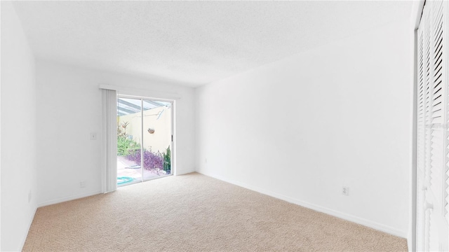 5045 Bermuda Cir Unit 12, Orlando, FL 32808 - carpeted spare room featuring baseboards and a textured ceiling
