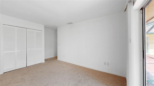 5045 Bermuda Cir Unit 12, Orlando, FL 32808 - unfurnished bedroom featuring carpet flooring and a closet
