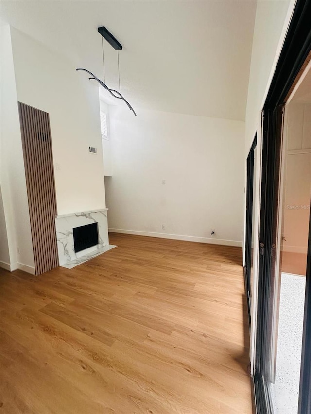 1050 E Michigan St Unit 1050B, Orlando, FL 32806 - unfurnished living room featuring light wood-style flooring and a fireplace