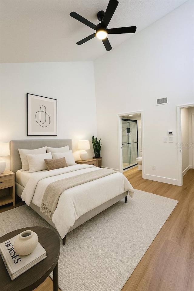 1050 E Michigan St Unit 1050B, Orlando, FL 32806 - bedroom featuring light wood finished floors, connected bathroom, high vaulted ceiling, and ceiling fan