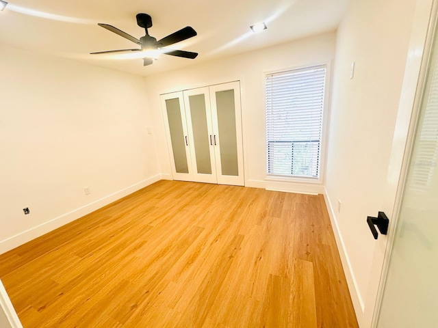 1050 E Michigan St Unit 1050B, Orlando, FL 32806 - unfurnished bedroom with light wood finished floors, a ceiling fan, and a closet