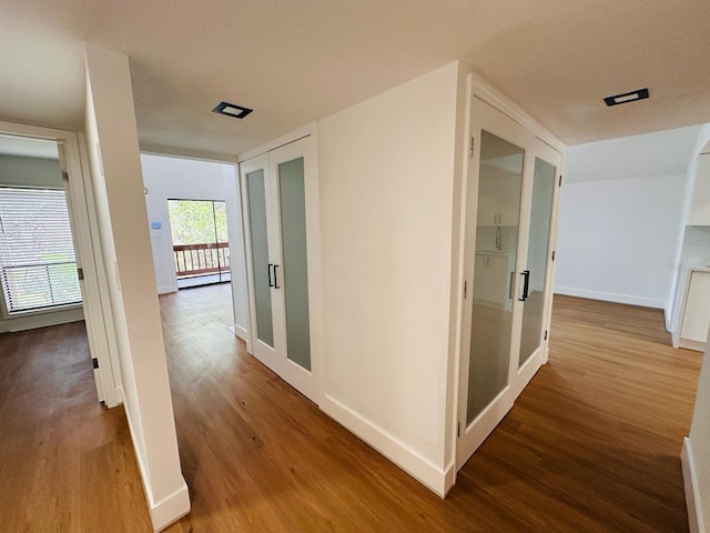 1050 E Michigan St Unit 1050B, Orlando, FL 32806 - hallway featuring wood finished floors and a baseboard heating unit