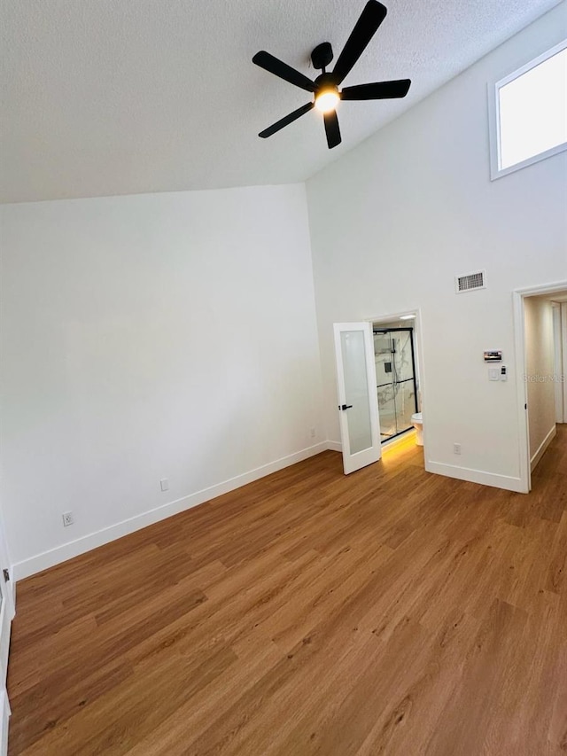 1050 E Michigan St Unit 1050B, Orlando, FL 32806 - unfurnished room featuring light wood finished floors, a textured ceiling, ceiling fan, and high vaulted ceiling
