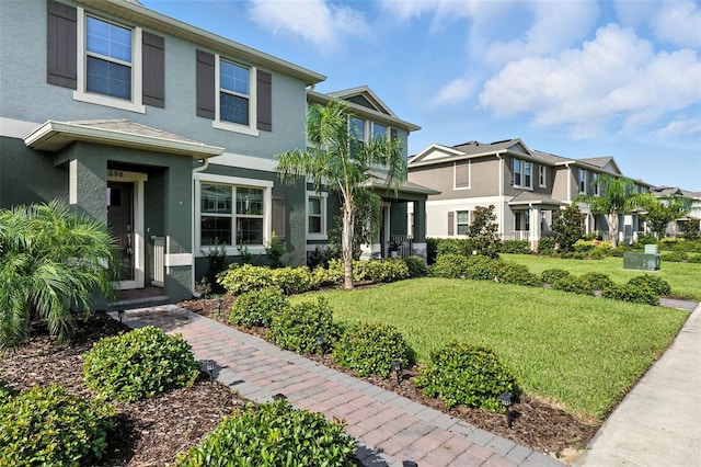 13298 Pontoon Rd, Winter Garden, FL 34787 - view of front of home with stucco siding, a front lawn, and a residential view