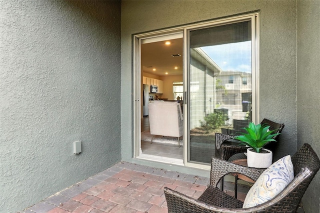 13298 Pontoon Rd, Winter Garden, FL 34787 - property entrance with stucco siding and a balcony
