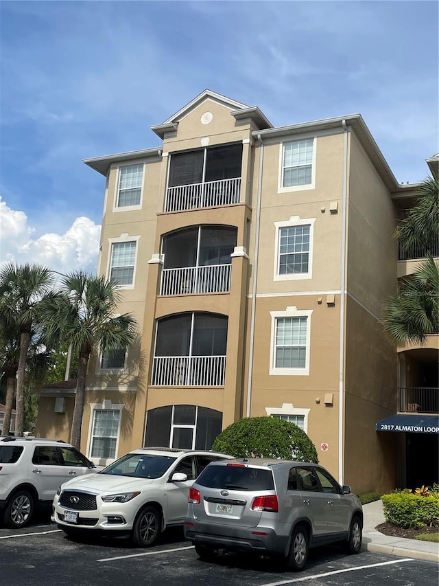 2817 Almaton Loop Unit 403, Kissimmee, FL 34747 - view of building exterior with uncovered parking