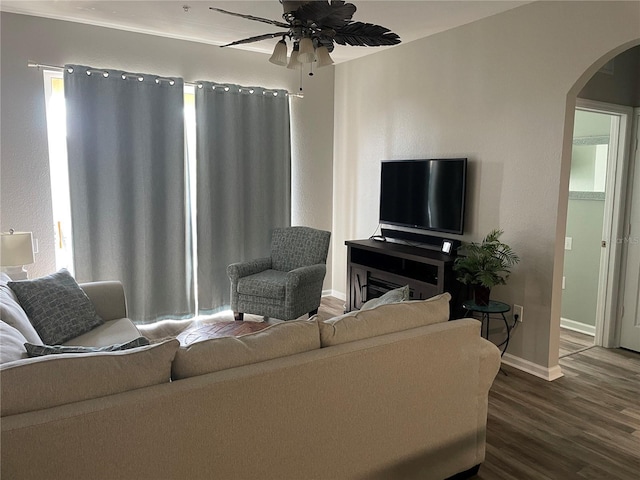 2817 Almaton Loop Unit 403, Kissimmee, FL 34747 - living room with arched walkways, dark wood finished floors, and a ceiling fan