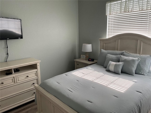 2817 Almaton Loop Unit 403, Kissimmee, FL 34747 - bedroom featuring a textured wall and dark wood finished floors
