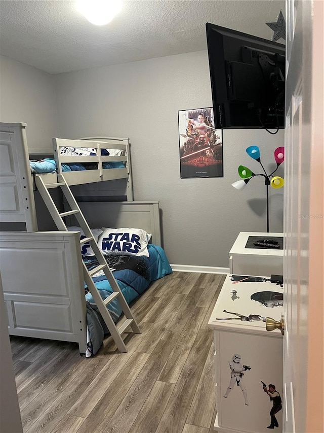 2817 Almaton Loop Unit 403, Kissimmee, FL 34747 - bedroom with wood finished floors and a textured ceiling