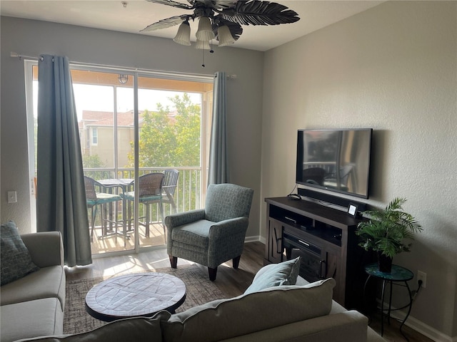 2817 Almaton Loop Unit 403, Kissimmee, FL 34747 - living area with a ceiling fan, wood finished floors, and a textured wall