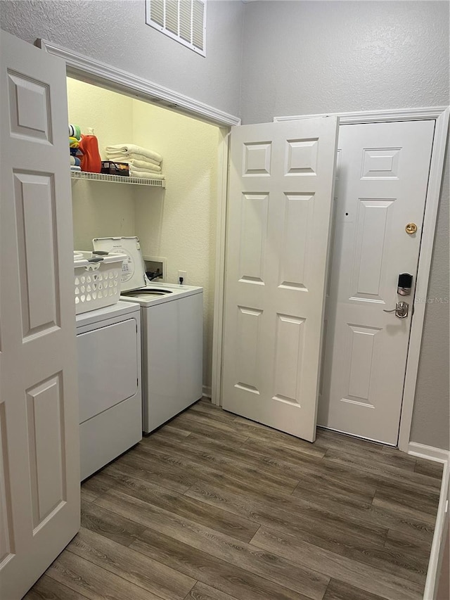 2817 Almaton Loop Unit 403, Kissimmee, FL 34747 - laundry area with washing machine and dryer and dark wood-type flooring