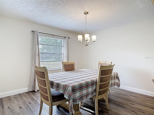 745 Mentmore Cir, Deltona, FL 32738 - dining room with a chandelier, wood finished floors, and a textured ceiling