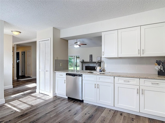 745 Mentmore Cir, Deltona, FL 32738 - kitchen featuring stainless steel dishwasher, ceiling fan, light wood finished floors, decorative backsplash, and a textured ceiling