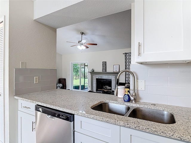 745 Mentmore Cir, Deltona, FL 32738 - kitchen with dishwasher, decorative backsplash, white cabinetry, ceiling fan, and light stone counters