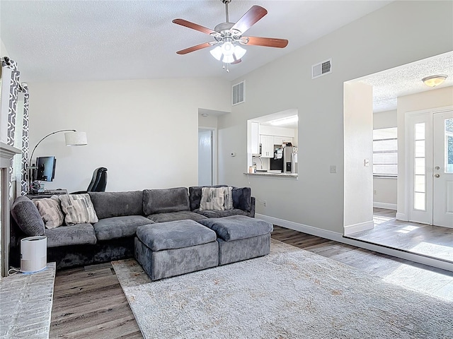 745 Mentmore Cir, Deltona, FL 32738 - living room with wood finished floors, lofted ceiling, ceiling fan, and a textured ceiling