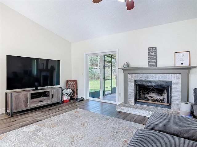 745 Mentmore Cir, Deltona, FL 32738 - living area featuring wood finished floors, a ceiling fan, a fireplace, a textured ceiling, and lofted ceiling