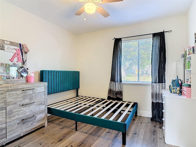 745 Mentmore Cir, Deltona, FL 32738 - bedroom featuring wood finished floors, a ceiling fan, and a textured ceiling