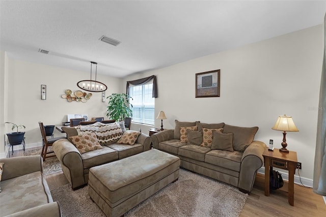 4920 Blanche Ct, Saint Cloud, FL 34772 - living area featuring light wood-style flooring and a chandelier