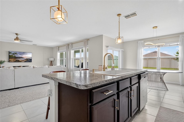 612 Auburn Grove Ter, Auburndale, FL 33823 - kitchen featuring light tile patterned flooring, stainless steel dishwasher, and pendant lighting