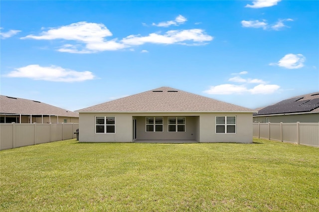 612 Auburn Grove Ter, Auburndale, FL 33823 - rear view of house with stucco siding, a fenced backyard, and roof with shingles