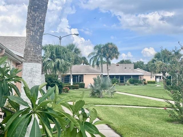 19 W Country Cove Way, Kissimmee, FL 34743 - back of house featuring a lawn and a shingled roof