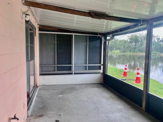 19 W Country Cove Way, Kissimmee, FL 34743 - unfurnished sunroom with a water view