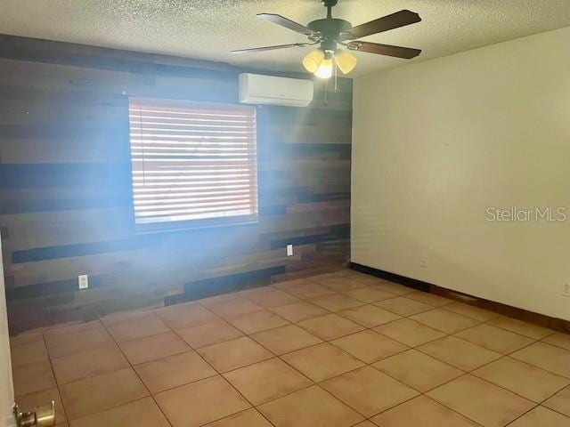 19 W Country Cove Way, Kissimmee, FL 34743 - spare room with an AC wall unit, a textured ceiling, ceiling fan, and light tile patterned flooring