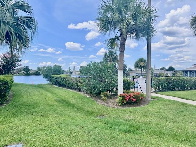19 W Country Cove Way, Kissimmee, FL 34743 - view of green lawn with a water view