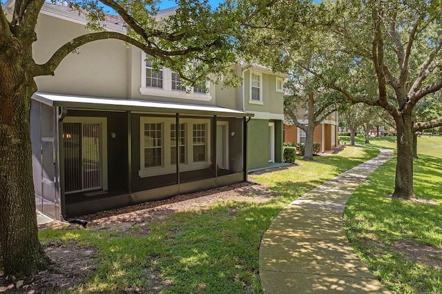 741 Ashworth Overlook Dr Unit B, Apopka, FL 32712 - back of house with a lawn and stucco siding