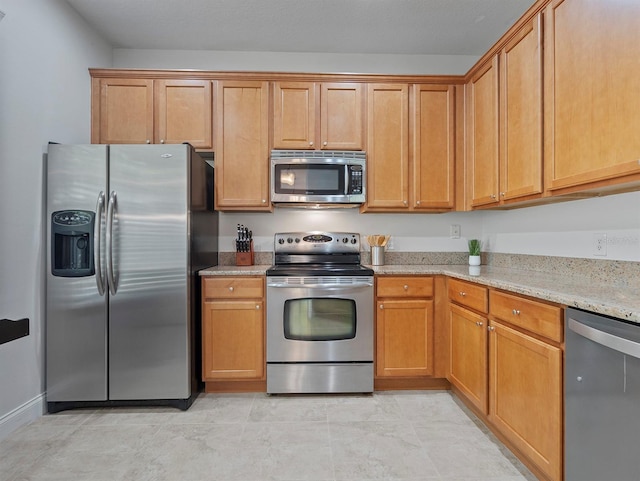 741 Ashworth Overlook Dr Unit B, Apopka, FL 32712 - kitchen with stainless steel appliances and light stone countertops
