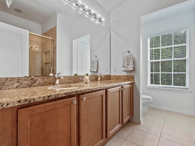 741 Ashworth Overlook Dr Unit B, Apopka, FL 32712 - bathroom featuring double vanity, plenty of natural light, tile patterned floors, and tiled shower