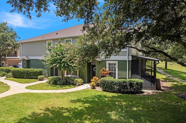 741 Ashworth Overlook Dr Unit B, Apopka, FL 32712 - view of front of house with a front yard, stucco siding, and a sunroom
