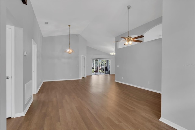 3507 Tenby Cir, Clermont, FL 34711 - unfurnished living room featuring ceiling fan, a chandelier, wood finished floors, and high vaulted ceiling