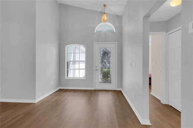 3507 Tenby Cir, Clermont, FL 34711 - entrance foyer with wood finished floors, a chandelier, and a towering ceiling