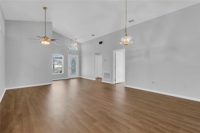 3507 Tenby Cir, Clermont, FL 34711 - unfurnished living room featuring high vaulted ceiling, wood finished floors, a ceiling fan, and a chandelier