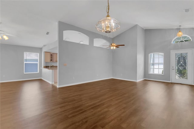 3507 Tenby Cir, Clermont, FL 34711 - unfurnished living room featuring a ceiling fan, a chandelier, dark wood finished floors, and high vaulted ceiling