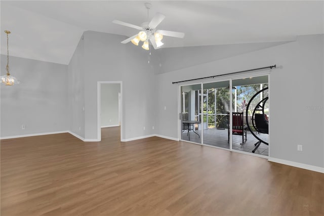 3507 Tenby Cir, Clermont, FL 34711 - spare room with wood finished floors, ceiling fan, high vaulted ceiling, and a chandelier
