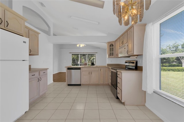 3507 Tenby Cir, Clermont, FL 34711 - kitchen with appliances with stainless steel finishes, a chandelier, a peninsula, glass insert cabinets, and lofted ceiling