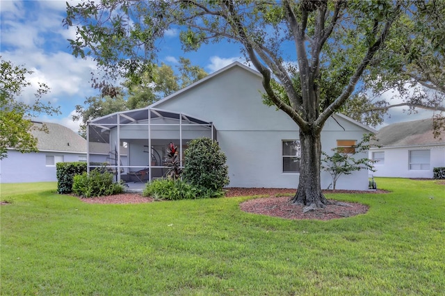 3507 Tenby Cir, Clermont, FL 34711 - back of property featuring a yard, stucco siding, and glass enclosure