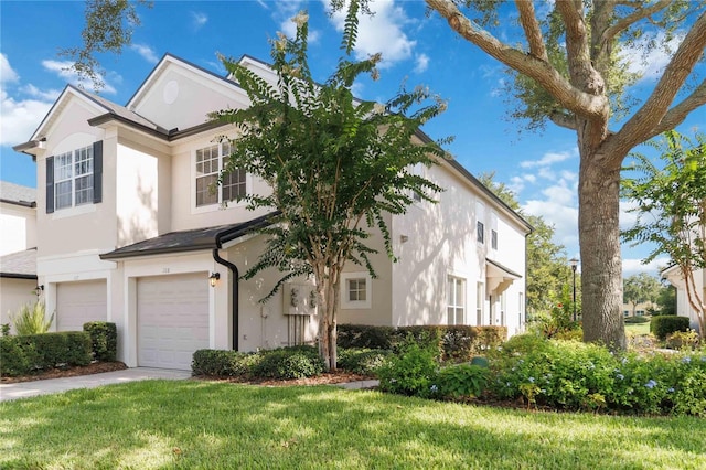 6059 Twain St Unit 108, Orlando, FL 32835 - view of front of house featuring an attached garage, stucco siding, a front yard, and concrete driveway