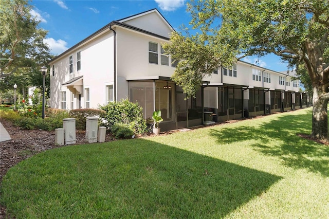 6059 Twain St Unit 108, Orlando, FL 32835 - rear view of house featuring stucco siding and a lawn