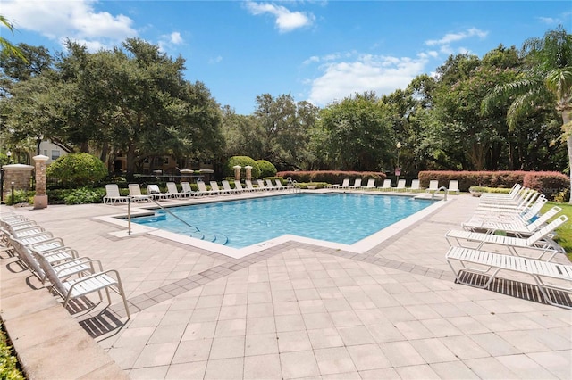 6059 Twain St Unit 108, Orlando, FL 32835 - community pool with a patio area and view of scattered trees