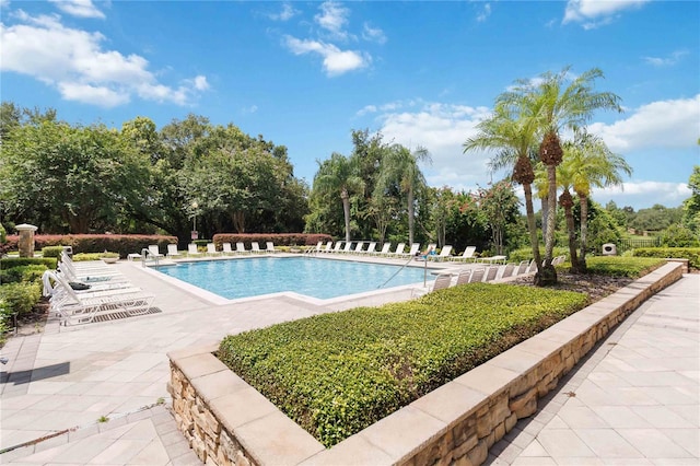 6059 Twain St Unit 108, Orlando, FL 32835 - community pool featuring a patio and view of scattered trees