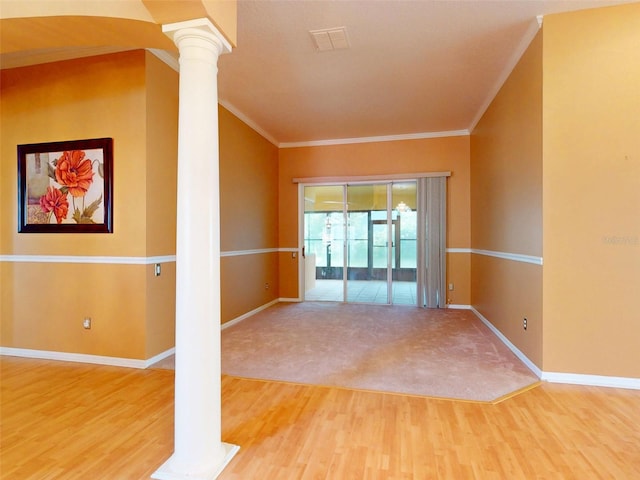 7985 Saint Giles Pl, Orlando, FL 32835 - empty room with decorative columns, crown molding, and wood finished floors