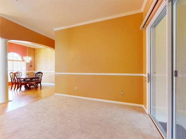 7985 Saint Giles Pl, Orlando, FL 32835 - carpeted empty room with a chandelier, arched walkways, ornamental molding, and ornate columns
