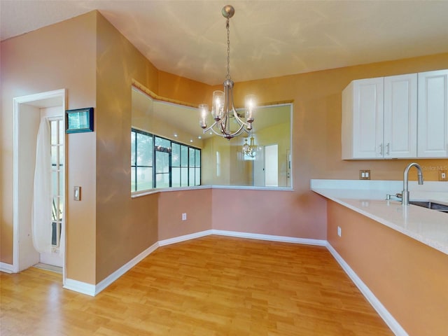 7985 Saint Giles Pl, Orlando, FL 32835 - unfurnished dining area featuring a chandelier and light wood-style floors