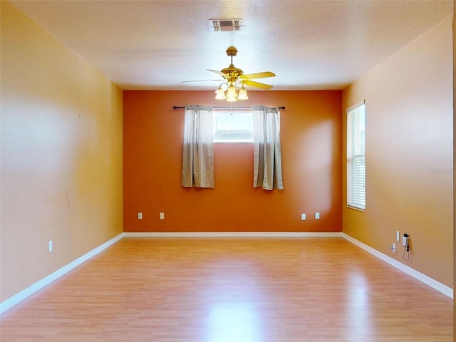 7985 Saint Giles Pl, Orlando, FL 32835 - empty room with light wood-type flooring, plenty of natural light, and a ceiling fan