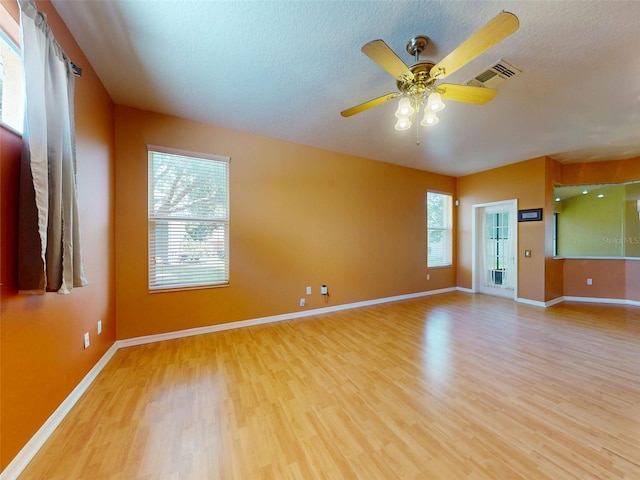 7985 Saint Giles Pl, Orlando, FL 32835 - empty room with wood finished floors, ceiling fan, and a textured ceiling