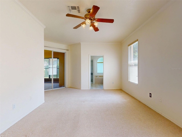 7985 Saint Giles Pl, Orlando, FL 32835 - unfurnished room with crown molding, healthy amount of natural light, a ceiling fan, and light colored carpet
