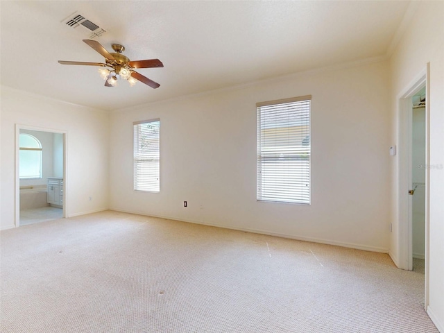 7985 Saint Giles Pl, Orlando, FL 32835 - empty room with healthy amount of natural light, light carpet, a ceiling fan, and ornamental molding